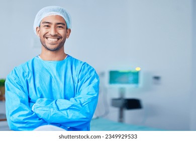 Portrait, surgeon and Asian man with arms crossed in hospital, healthcare and wellness. Face, happy doctor and medical professional, expert nurse and confident surgery employee in scrubs in Cambodia