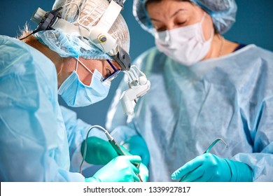 Portrait of a surgeon close-up. Surgeons operate on a patient. Tense, serious faces. Real operation. Tensioned atmosphere in the operating room. - Powered by Shutterstock