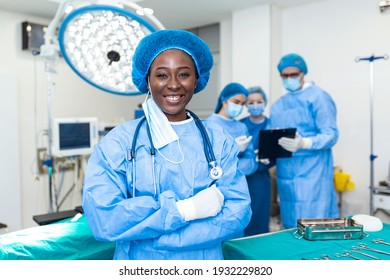 Portrait of surgeon standing in operating room, ready to work on a patient. African American Female medical worker surgical uniform in operation theater.