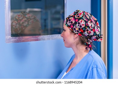 Portrait Of A Surgeon Woman Looking Through An Operating Room Window