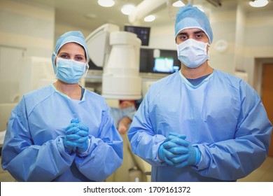 Portrait Of Surgeons Standing In Operation Theater At Hospital. Healthcare Workers In The Coronavirus Covid19 Pandemic
