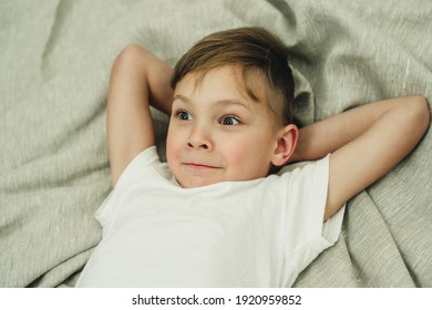 portrait of a surprised boy on the bed