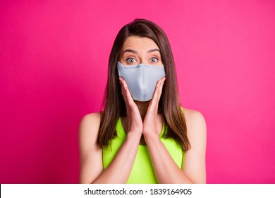 Portrait Of Surprised Brunette Lady Wear Blue Fabric Face Mask Isolated On Bright Pink Background