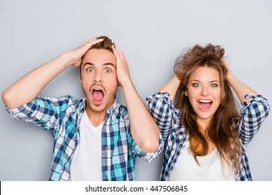Portrait of surprised man and woman screaming and touching hair