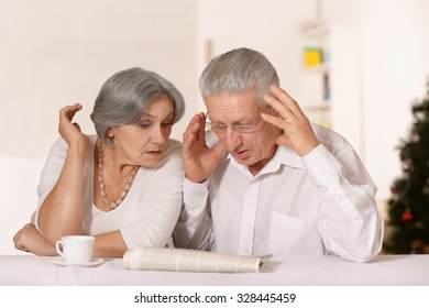 Portrait Of A Surprised Old Couple Reading Newspaper