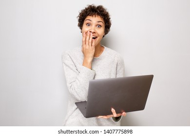 Portrait Of Surprised Young African American Woman With Laptop Computer