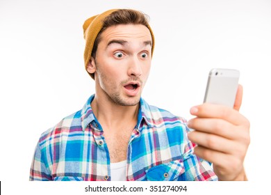 A Portrait Of Surprised Young Man With Mobile Phone