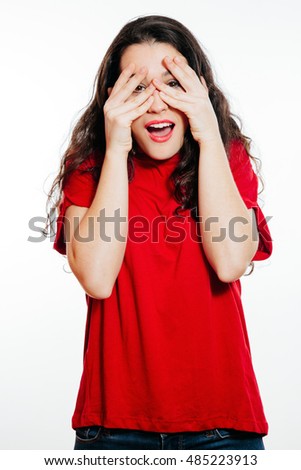 Portrait of surprised young woman covering eyes with amazement. Isolated on white