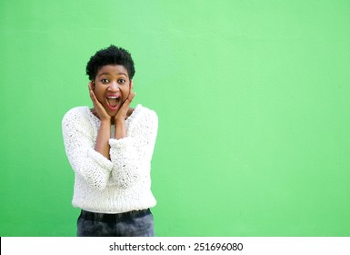 Portrait of a surprised young woman with hands on face 
