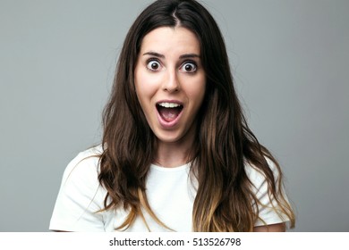 Portrait of surprised young woman looking at camera.
