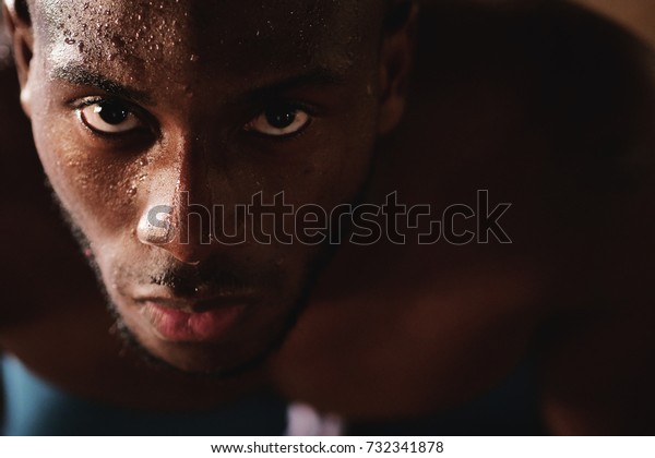Portrait of a sweaty and muscular man breathing\
hard on the hard work just finished. Concept of: breathing,\
workout, gym and workout and\
fatigue.