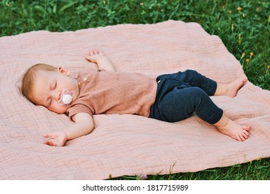 Portrait Of Sweet Baby Sleeping Outside, Child Napping On Blanket In Garden Or Park