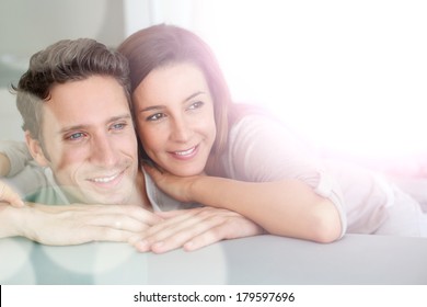 Portrait Of Sweet Couple Sitting In Sofa