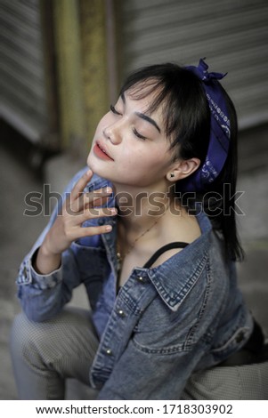 
Portrait of Sweet Girl wearing a black tanktop and jeans jacket
