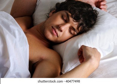 Portrait of a sweet sleeping young beautiful   man lying on back
