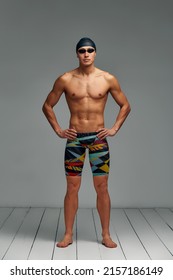 Portrait Of A Swimmer In A Cap And Mask, Full-length Portrait, Young Athlete Swimmer Wearing A Cap And Mask For Swimming, Copies Of Space, Gray Background