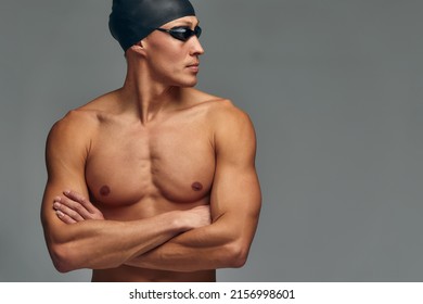 Portrait Of A Swimmer In A Cap And Mask, Half-length Portrait, Young Athlete Swimmer Wearing A Cap And Mask For Swimming, Copies Of Space, Gray Background.