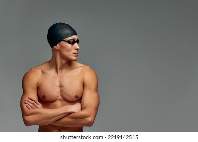 Portrait Of A Swimmer In A Cap And Mask, Half-length Portrait, Young Athlete Swimmer Wearing A Cap And Mask For Swimming, Copies Of Space, Gray Background.