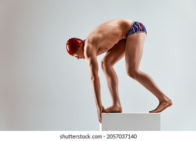 Portrait of a swimmer who is preparing for a jump. The concept of swimming and water games. Front view. Mixed media - Powered by Shutterstock