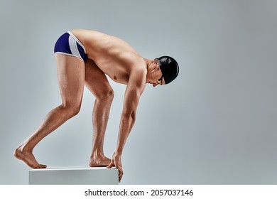 Portrait of a swimmer who is preparing for a jump. The concept of swimming and water games. Front view. Mixed media - Powered by Shutterstock