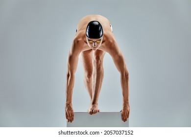 Portrait of a swimmer who is preparing for a jump. The concept of swimming and water games. Front view. Mixed media - Powered by Shutterstock