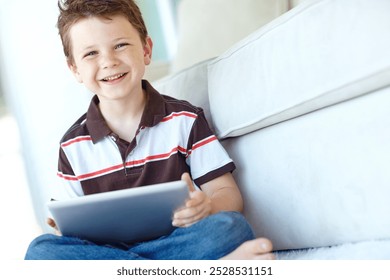 Portrait, tablet and happy child relax in home for learning on living room floor. Boy, kid and digital technology for internet addiction, scroll app or playing game for education on carpet in Germany - Powered by Shutterstock