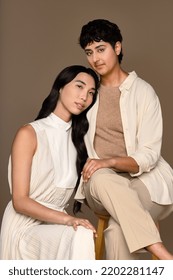 Portrait Of A Taiwanese Transgender Woman In Her 20's And A Punjabi Person In Their 20's Posing Together On A Neutral Background.