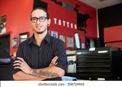 Portrait Of Tattoo Artist Standing Inside Parlor