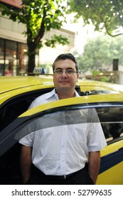 Portrait Of A Taxi Driver With Cab