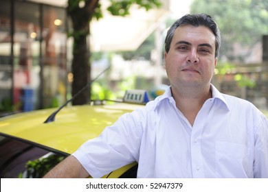 portrait of a taxi driver with cab