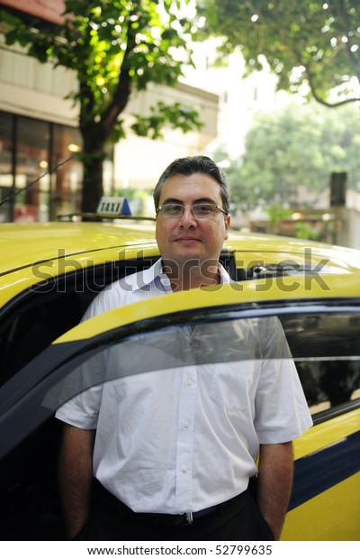portrait of a taxi driver with\
cab