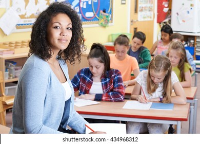 Portrait Of Teacher In Class With Pupils
