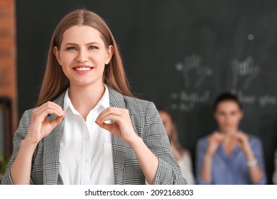 Portrait Of Teacher Conducting Courses For Deaf Mute People In Classroom