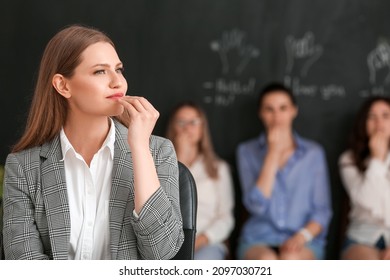 Portrait Of Teacher Conducting Courses For Deaf Mute People In Classroom