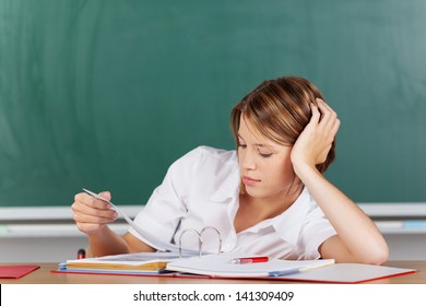 Portrait Of Teacher Thinking And Looking On Her Lesson Plan