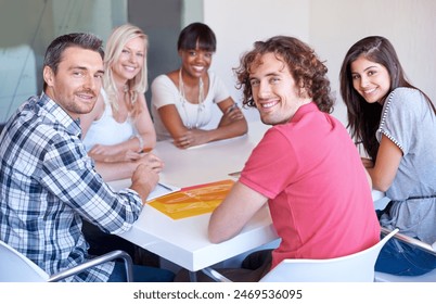 Portrait, team and happy business people at table in meeting together, cooperation or collaboration in startup. Face, smile or creative group of designers with photograph, brainstorming strategy plan - Powered by Shutterstock