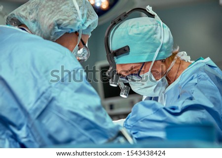 Portrait of a team of surgeons at work. During surgery. Concept medicine, saving lives.