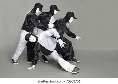 Portrait Of A Team Of Young Break Dancers With Elements Of Dance In Mask.