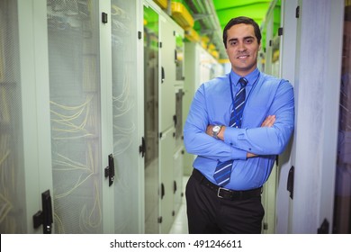 Portrait of technician standing with arms crossed in a server room