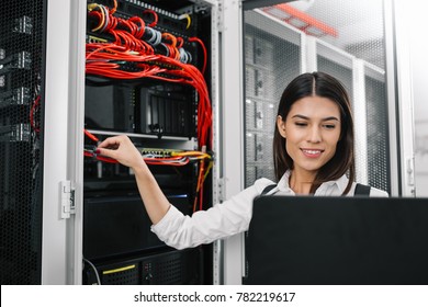 Portrait Of Technician Working On Laptop In Server Room