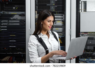 Portrait of technician working on laptop in server room - Powered by Shutterstock