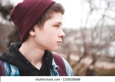 Portrait Of Teen Boy 17-18 Year Old Wearing Knitted Hat Outdoors Close Up. 