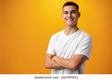 Portrait Of A Teen Boy Smiling Against Yellow Background