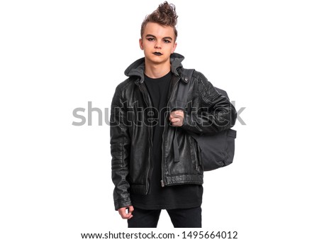 Portrait of teen boy student with spooking make-up holds bag, isolated on white background. Teenager with backpack in style of punk goth dressed in black. Problems of transitional age.