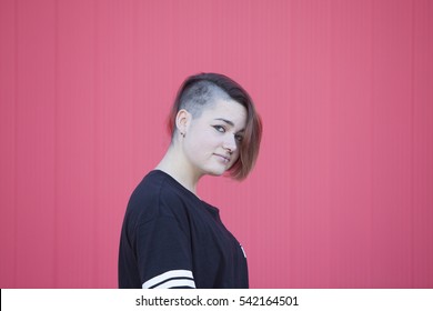 Portrait Of A Teen Gay Woman On A Pink Wall