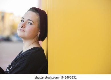 Portrait Of A Teen Gay Woman On A Yellow Wall