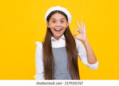 Portrait of teen girl making ok gesture, isolated background. Young teenager smiling and giving okey sign. Happy cute child showing okay. Excited face, cheerful emotions of teenager girl.