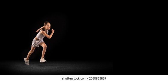 Portrait Of Teen Girl, Professional Athlete Running Marathon, Training Isolated Over Black Background. Concept Of Action, Sport, Healthy Life, Competition, Motion, Physical Activity. Copy Space For Ad