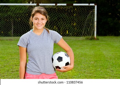 Portrait Of Teen Girl Soccer Player On Field