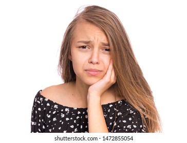 Portrait Of Teen Girl Touching Her Face Suffering Toothache Looking Tired And Sad. Dental Problem. Unhappy Beautiful Caucasian Young Teenager Suffering From Tooth Pain, Isolated On White Background.